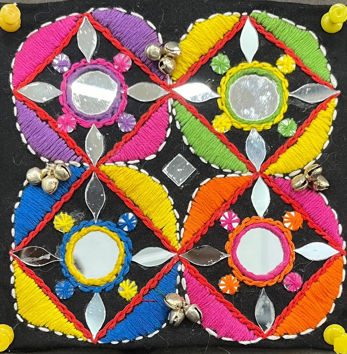 Banjara embroidery sample with mirror work and bright petals