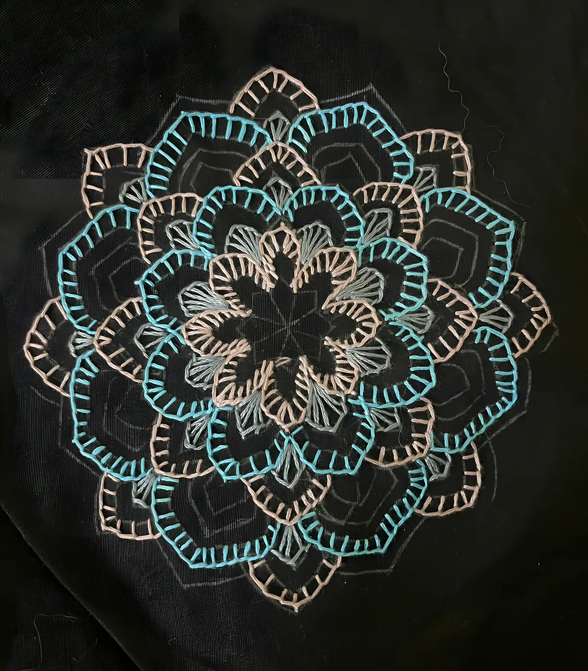 Embroidered mandala in teal and pink on black