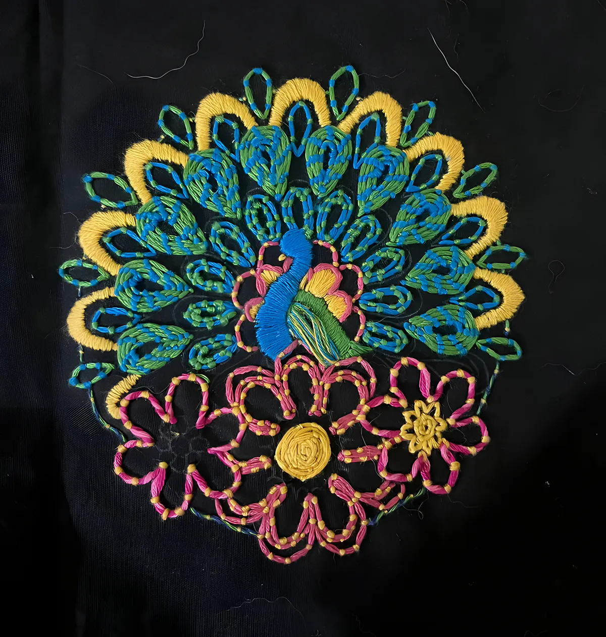 Embroidered peacock and flower mandala on black