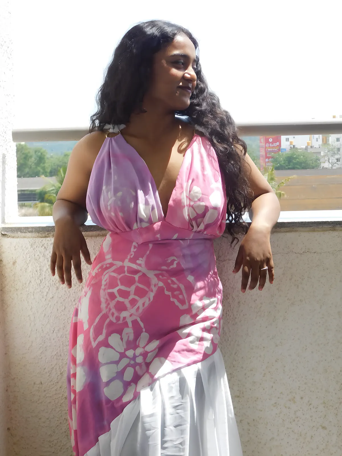 The batik gown's turtle and coral motifs in daylight