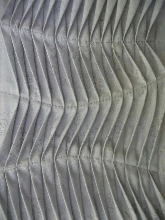 Pin tucks sample folding into chevrons